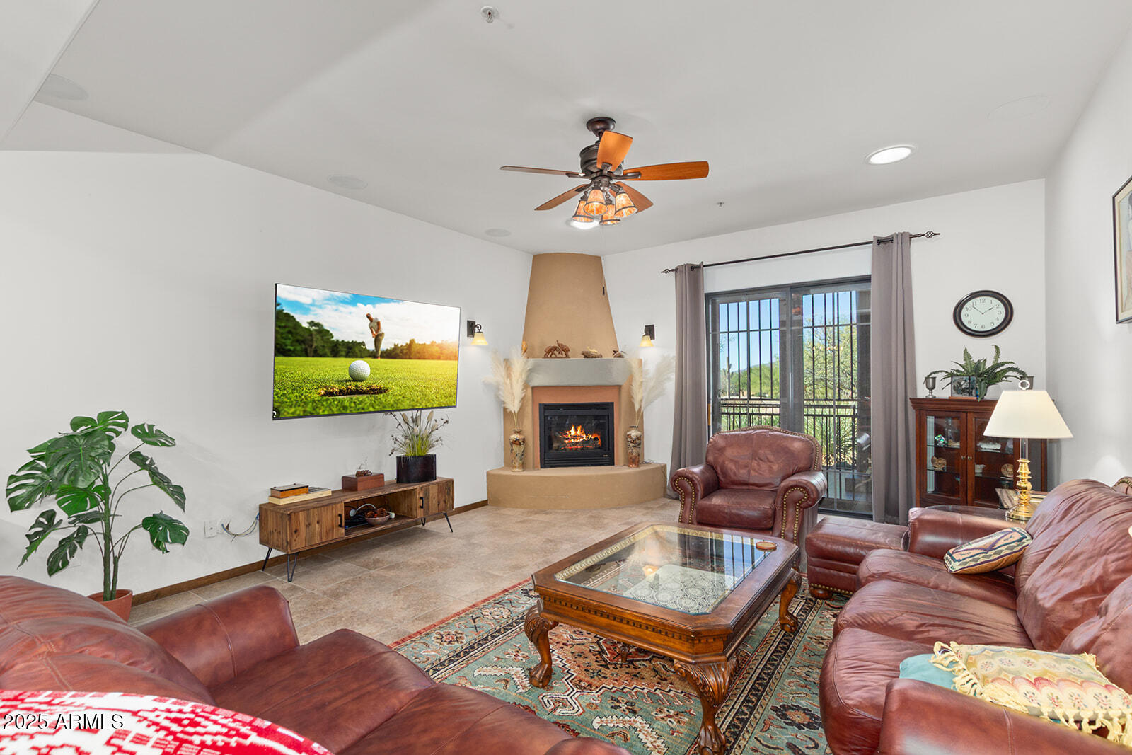 a living room with furniture a fireplace and a flat screen tv