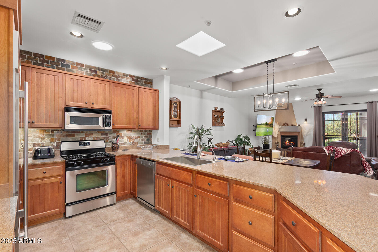 36601 North Mule Train Road, Unit 45B Carefree, AZ 85377 - Photo 14 of 41 a kitchen with kitchen island granite countertop a sink stainless steel appliances and cabinets