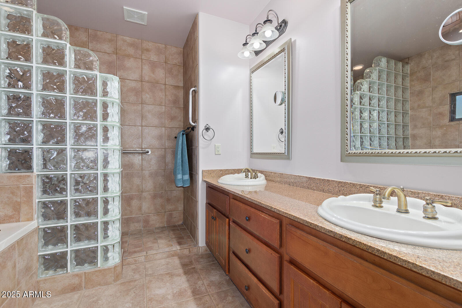 36601 North Mule Train Road, Unit 45B Carefree, AZ 85377 - Photo 18 of 41 a bathroom with a granite countertop sink a mirror and a shower