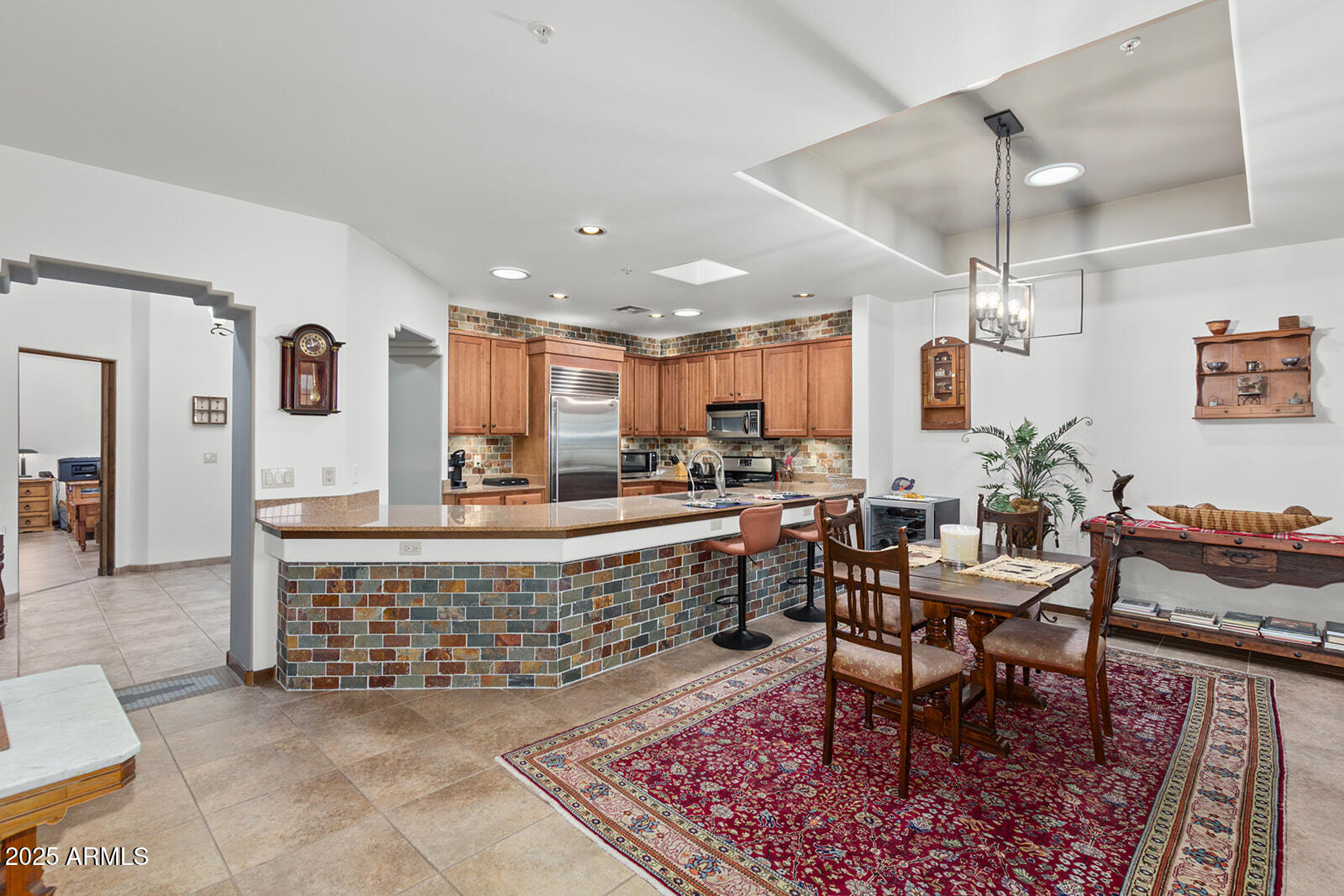 36601 North Mule Train Road, Unit 45B Carefree, AZ 85377 - Photo 7 of 41 a living room with a dining table and paintings on the wall