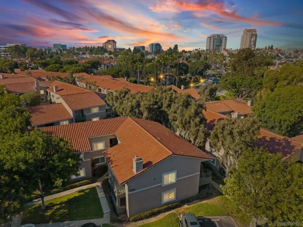 an aerial view of multiple houses with a yard