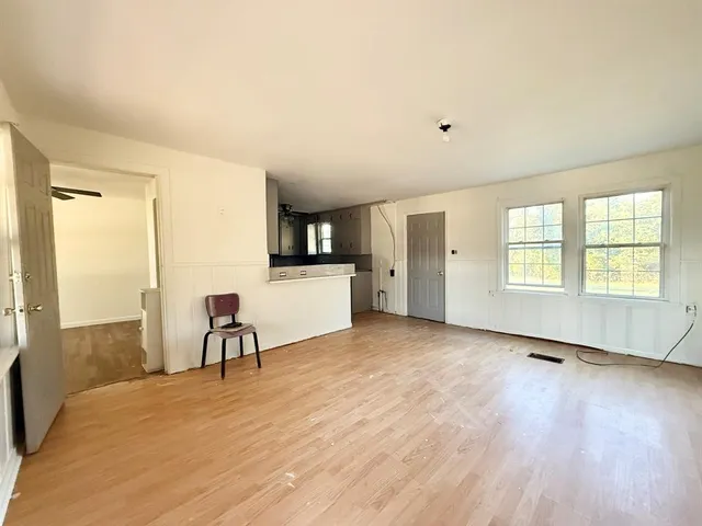 a view of a livingroom with furniture and a kitchen