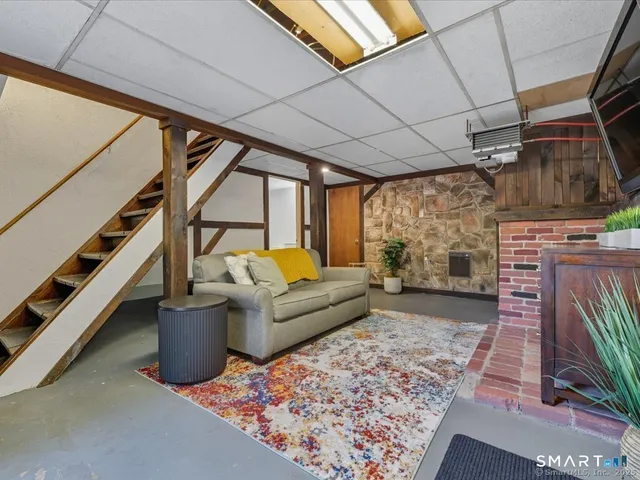 a living room with furniture and a fireplace