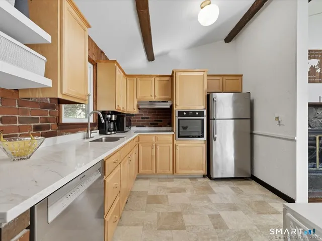 a kitchen with refrigerator and cabinets