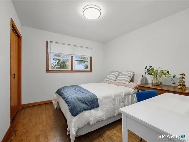 a bedroom with two beds and a potted plant