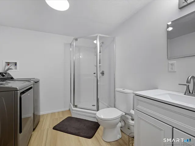 a bathroom with a toilet a sink and shower