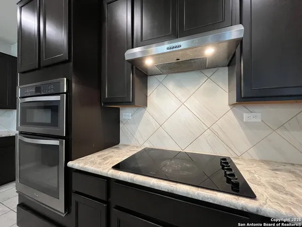 a view of a kitchen counter space and stainless steel appliances