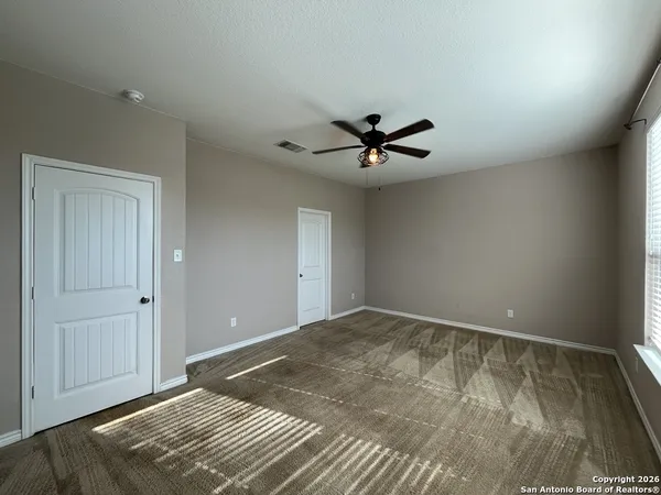 a view of a big room with wooden floor and closet