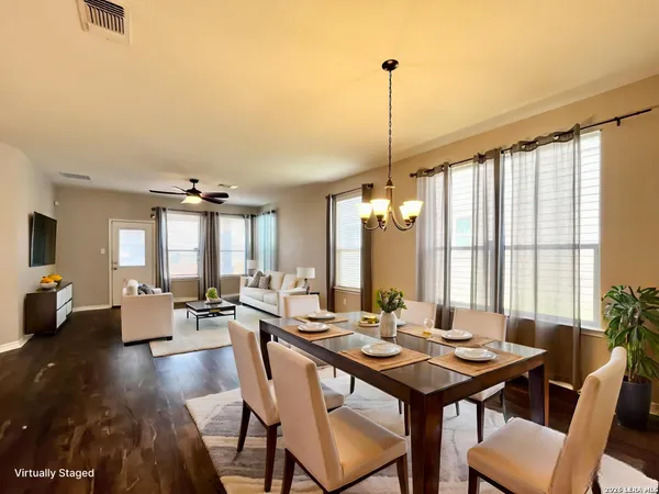 a view of a a dining room with furniture window and wooden floor
