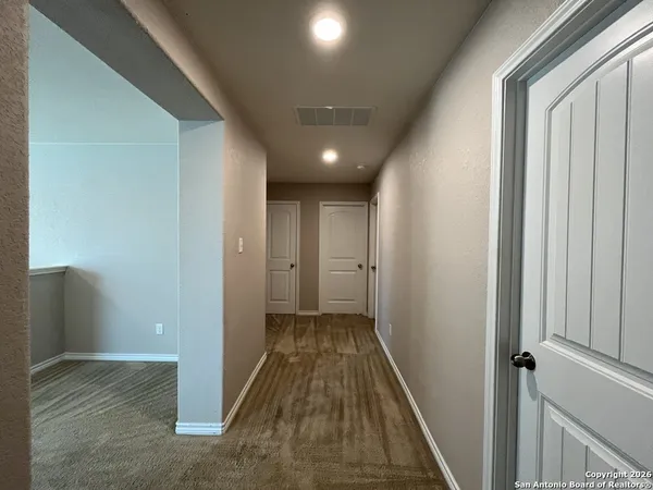 a view of wooden floor and window in a room