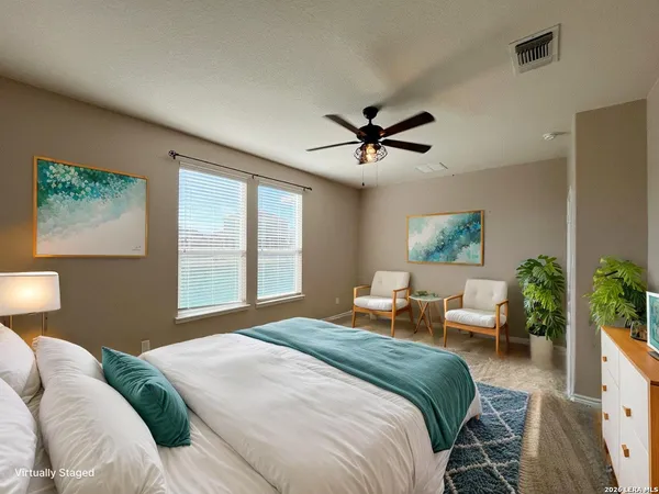 a bedroom with a large bed and a window