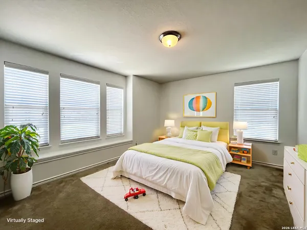 a bedroom with a bed and a potted plant