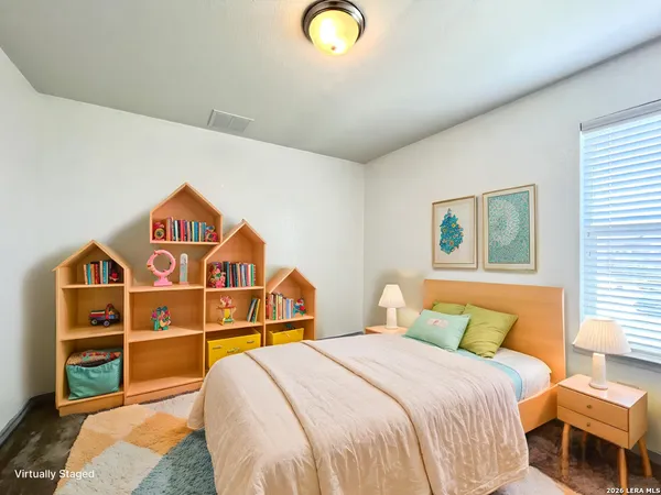 a bedroom with a bed and a view of kitchen