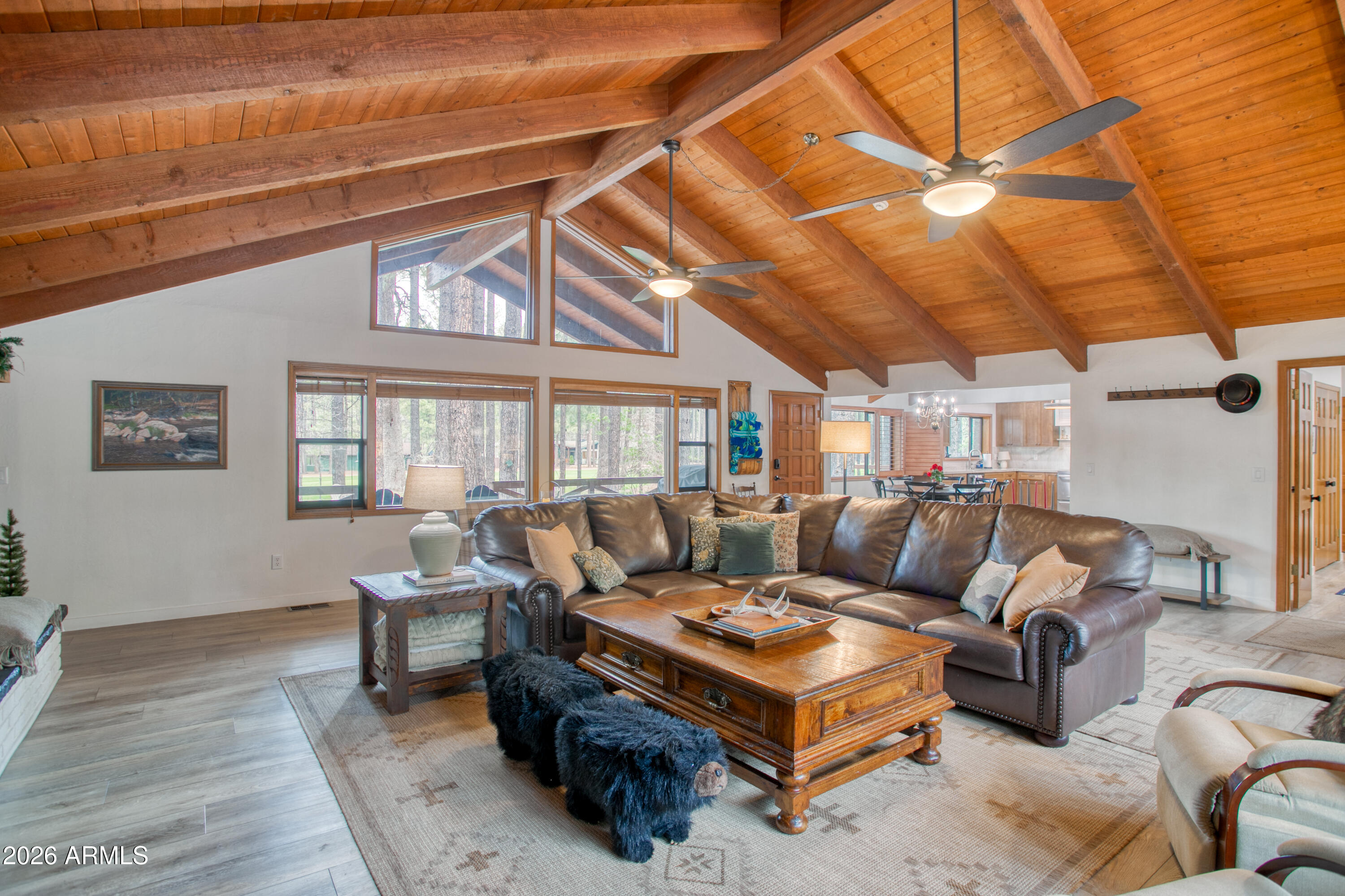 7414 Geronimo Road Pinetop, AZ 85935 - Photo 15 of 67 a living room with furniture a flat screen tv and a large window