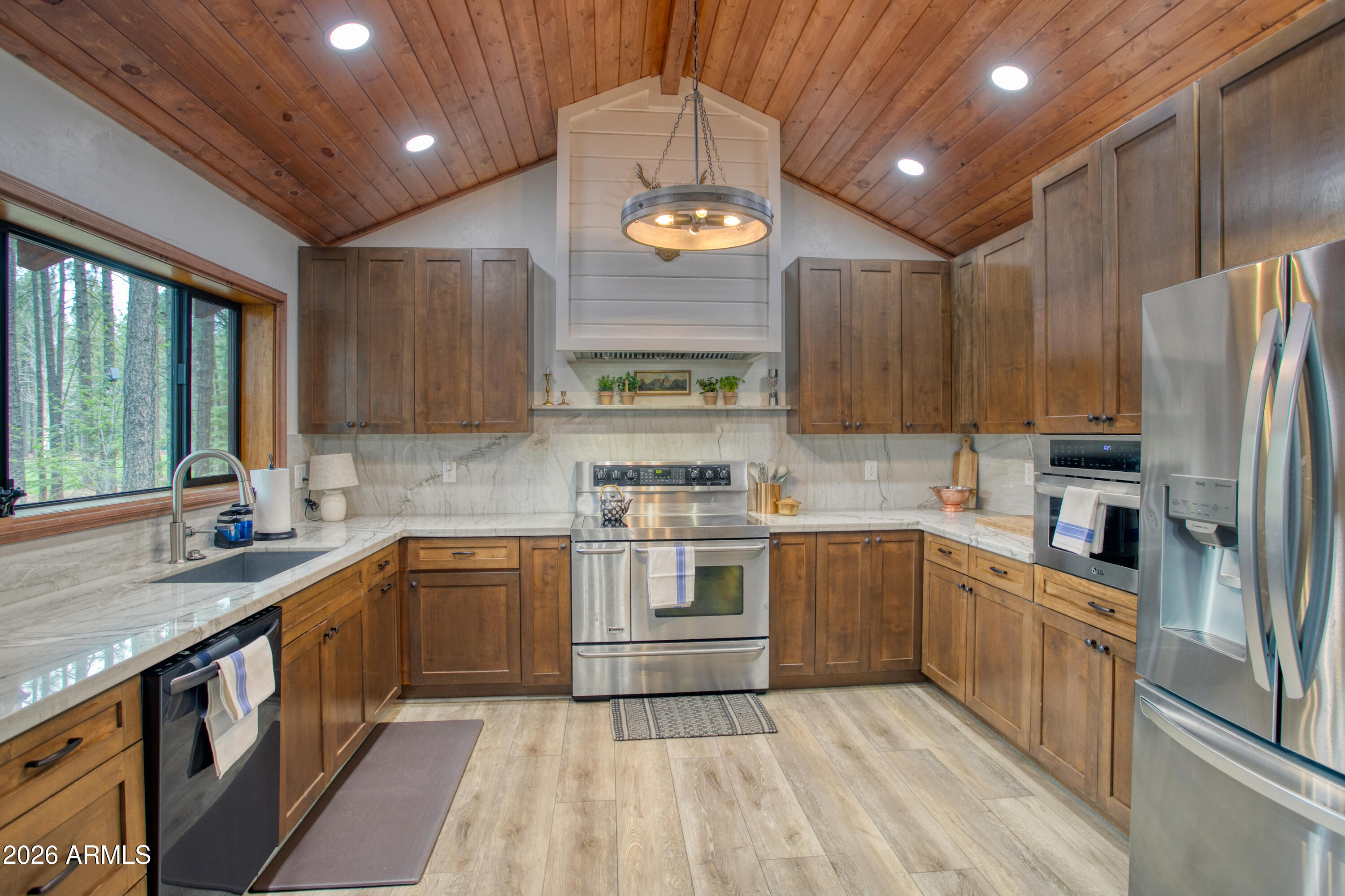 7414 Geronimo Road Pinetop, AZ 85935 - Photo 20 of 67 a kitchen with stainless steel appliances granite countertop a sink a stove and a refrigerator