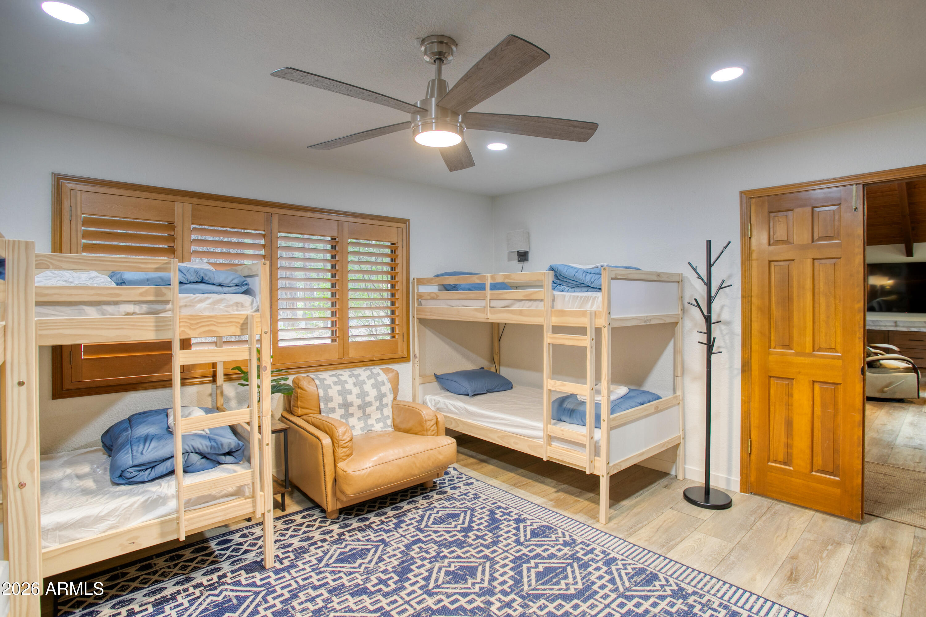7414 Geronimo Road Pinetop, AZ 85935 - Photo 23 of 67 a bedroom with a bed and a couch