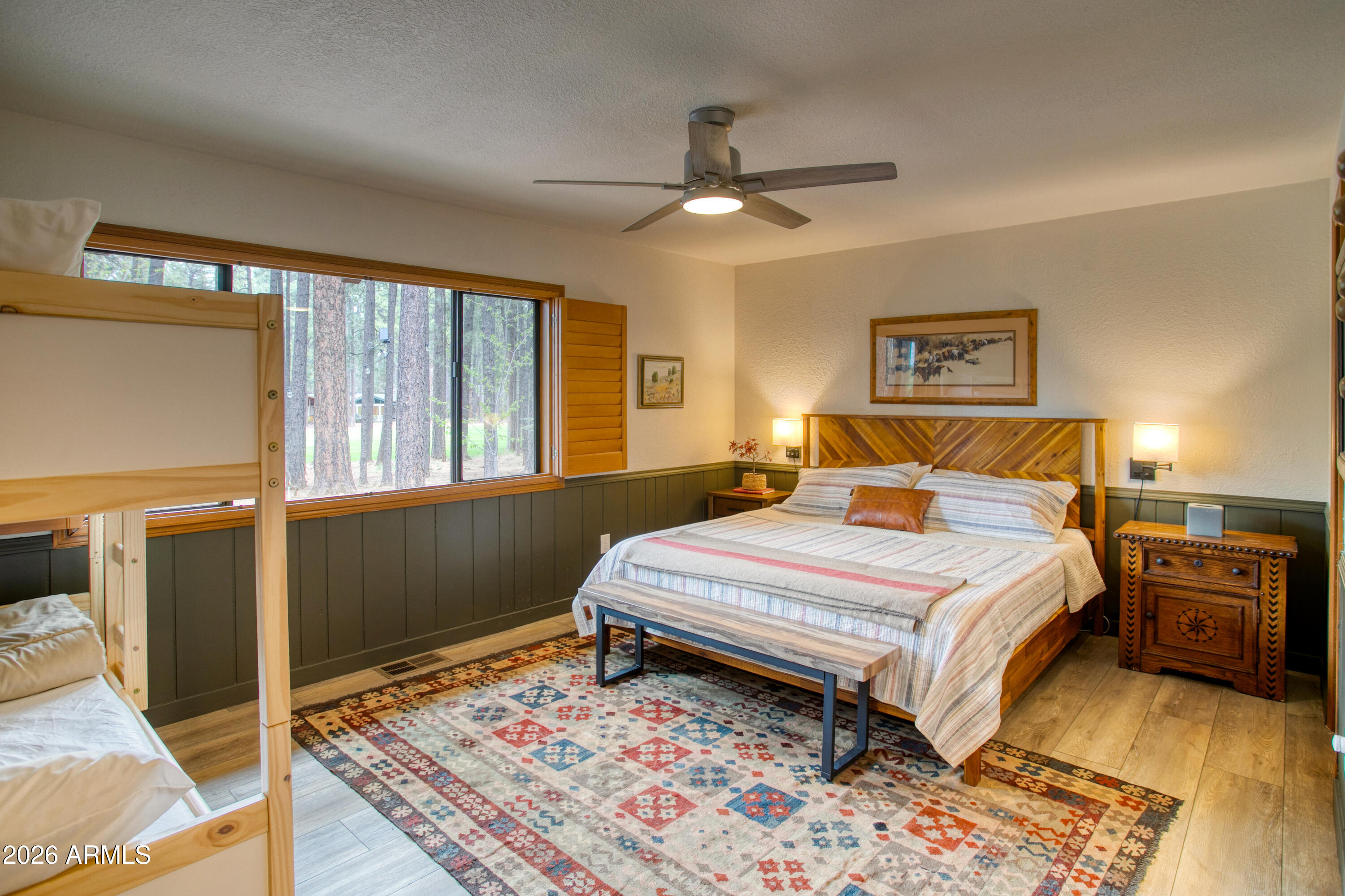 7414 Geronimo Road Pinetop, AZ 85935 - Photo 25 of 67 a bedroom with a bed and wooden floor