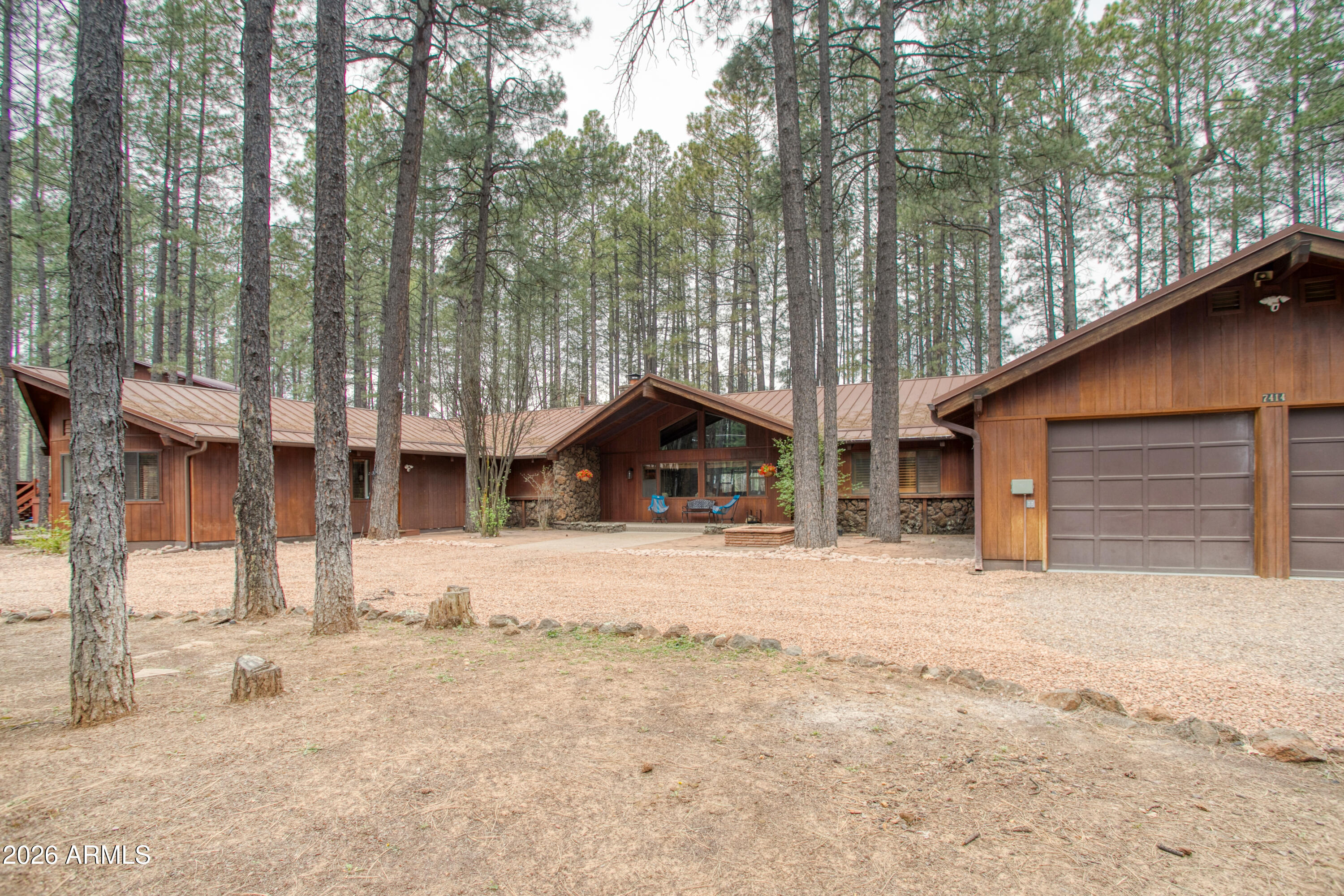 7414 Geronimo Road Pinetop, AZ 85935 - Photo 3 of 67 a wooden house with trees in front of it