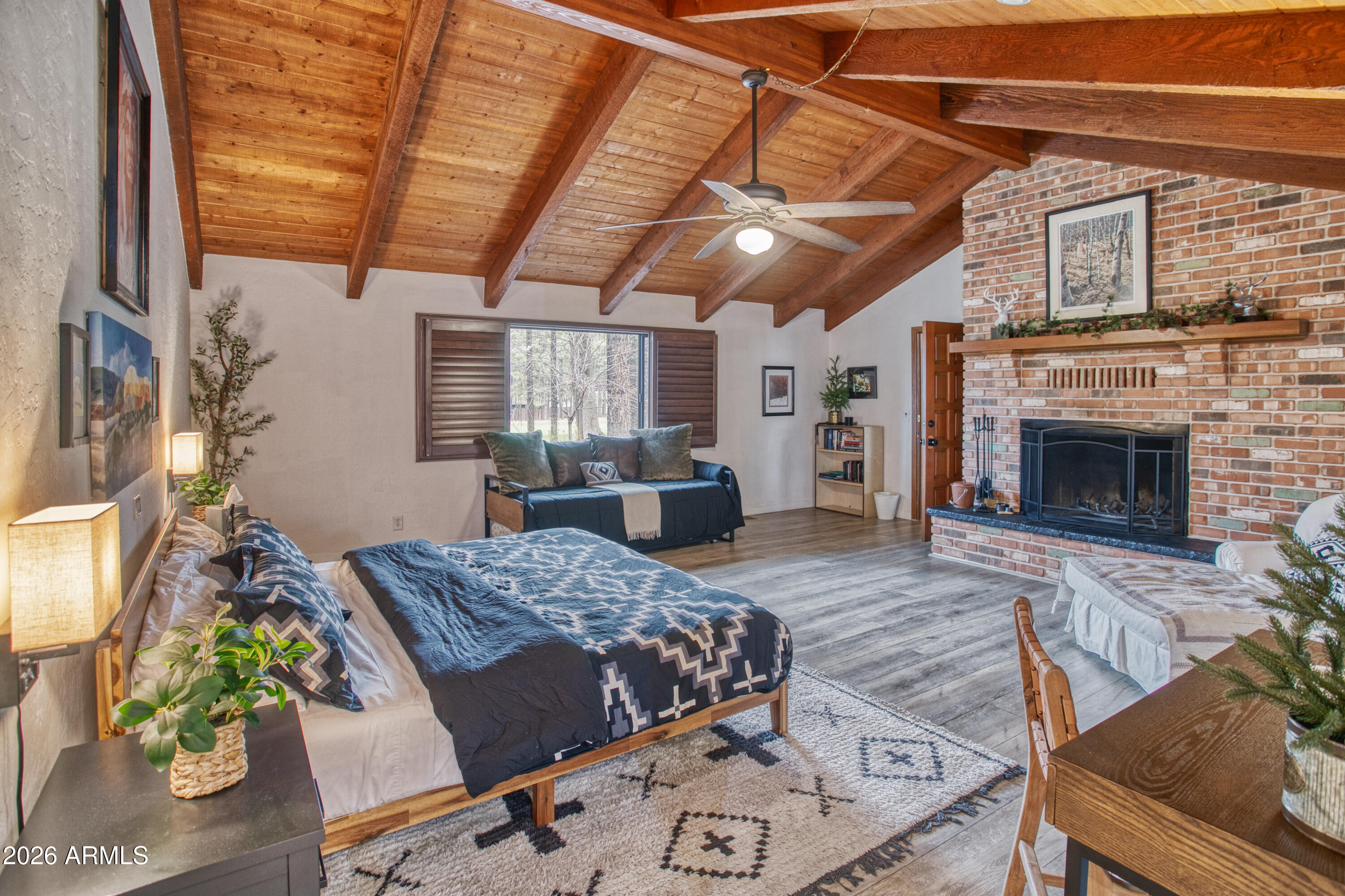 7414 Geronimo Road Pinetop, AZ 85935 - Photo 32 of 67 a bed room with a bed and a fireplace