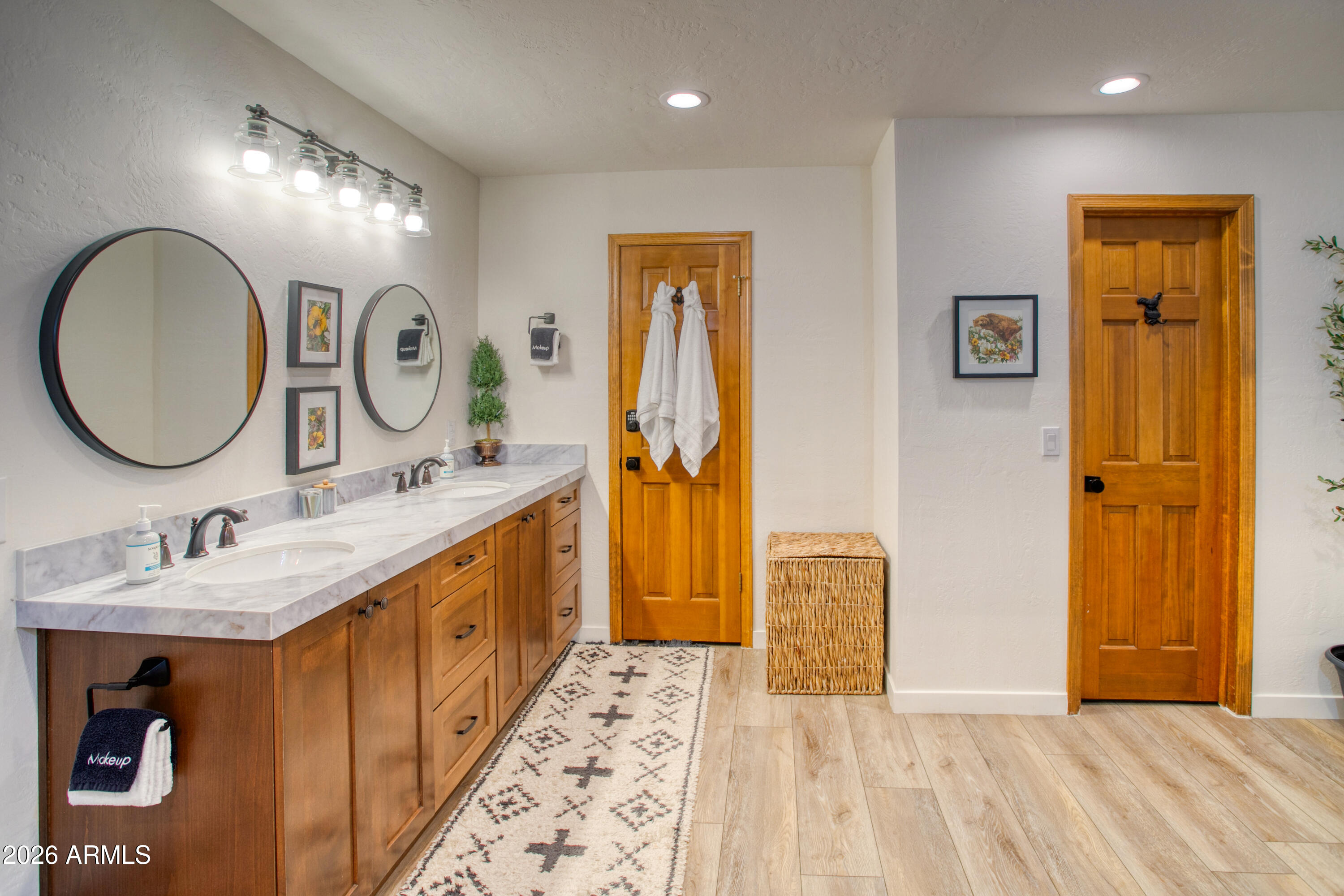 7414 Geronimo Road Pinetop, AZ 85935 - Photo 33 of 67 a bathroom with a double vanity sink and a mirror