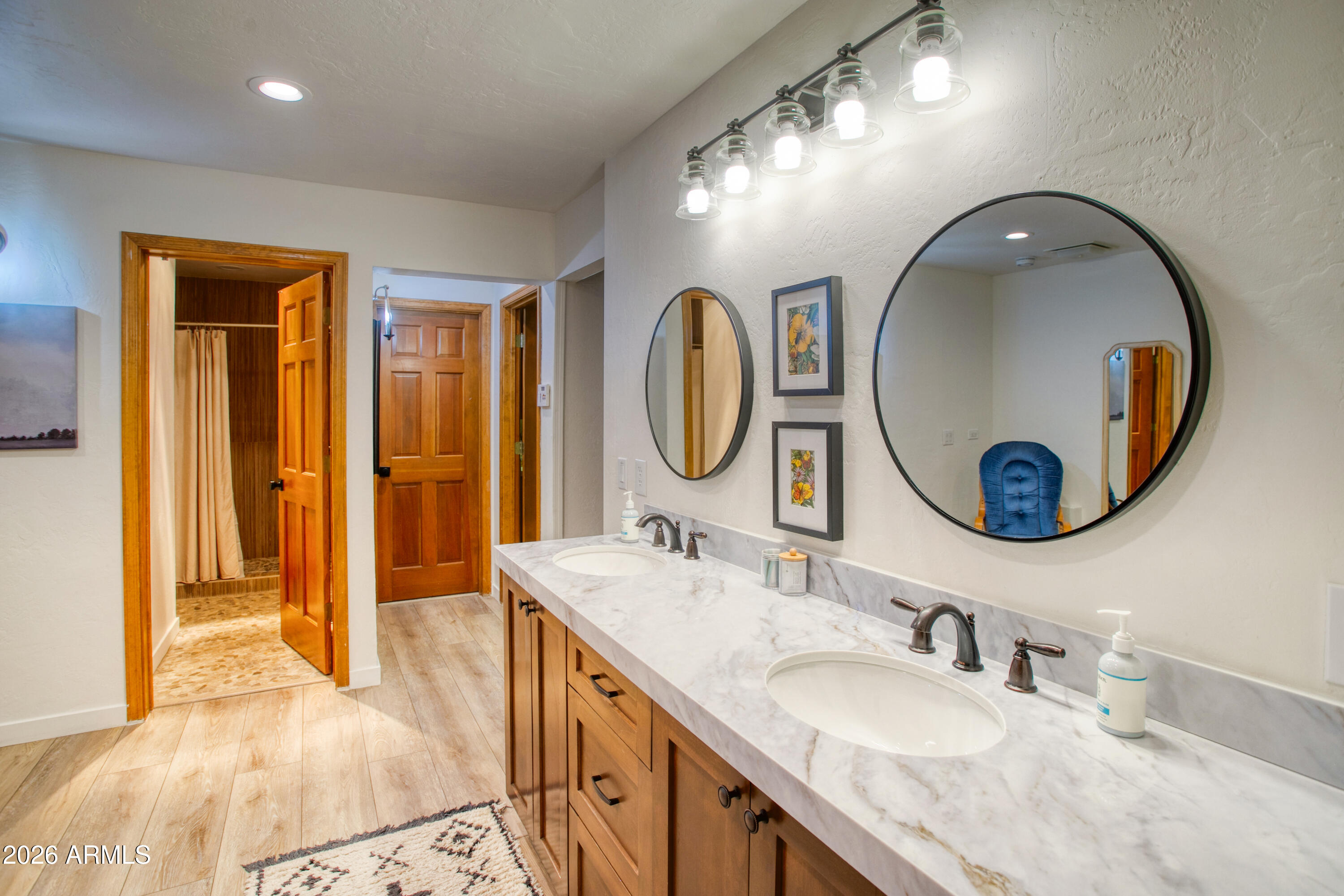 7414 Geronimo Road Pinetop, AZ 85935 - Photo 37 of 67 a bathroom with a granite countertop double vanity sink and a mirror
