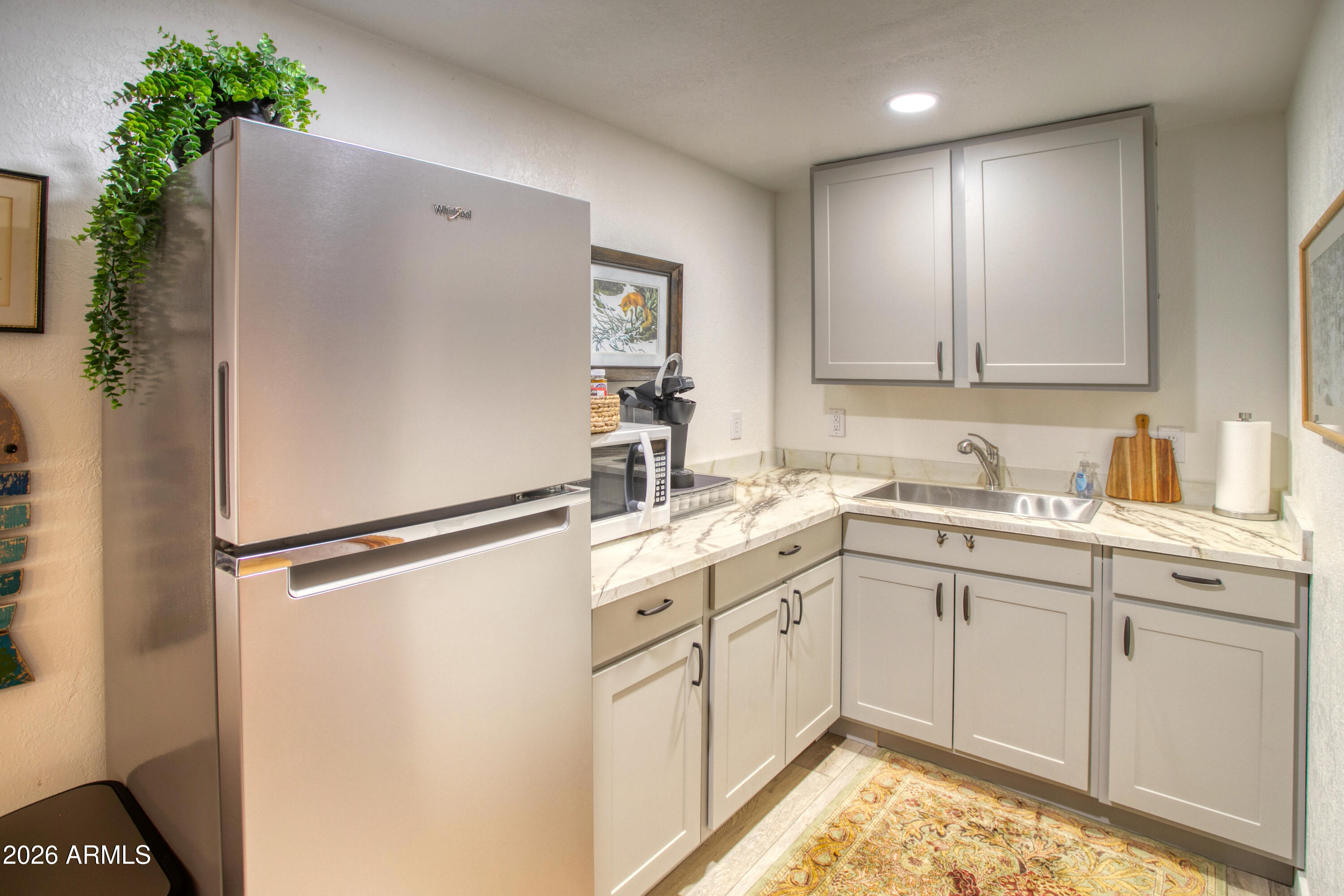 7414 Geronimo Road Pinetop, AZ 85935 - Photo 45 of 67 a white refrigerator freezer sitting inside of a kitchen