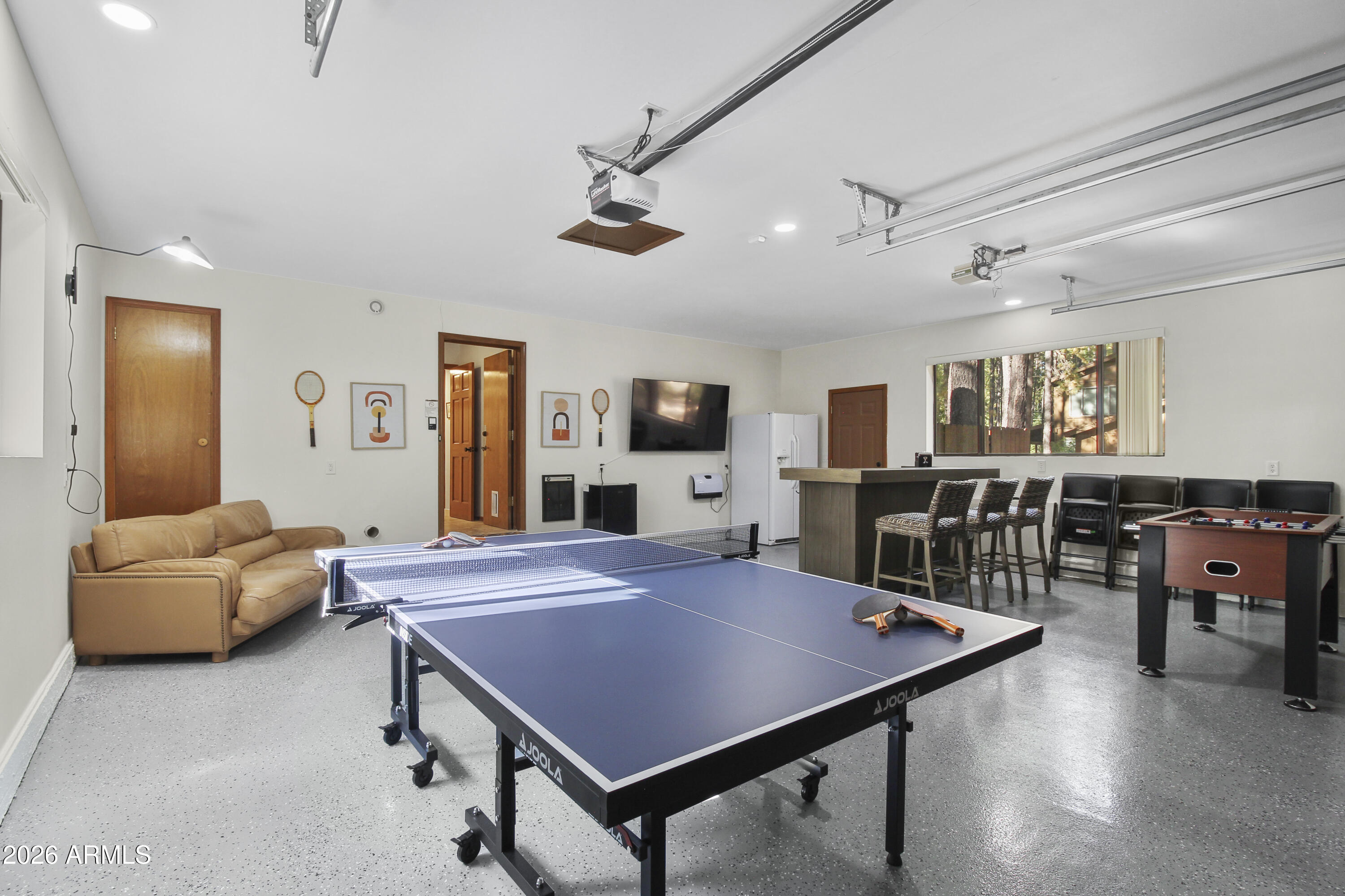 7414 Geronimo Road Pinetop, AZ 85935 - Photo 50 of 67 a living room with furniture a flat screen tv and a table