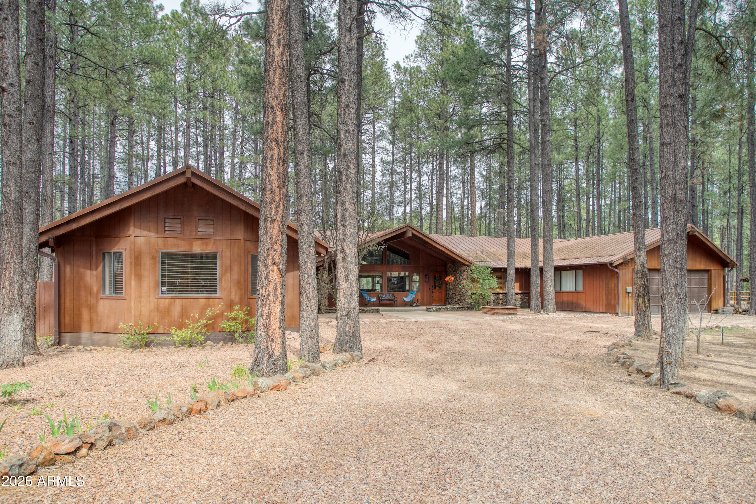 7414 Geronimo Road Pinetop, AZ 85935 - Photo 5 of 67 a view of a house with a yard covered in snow