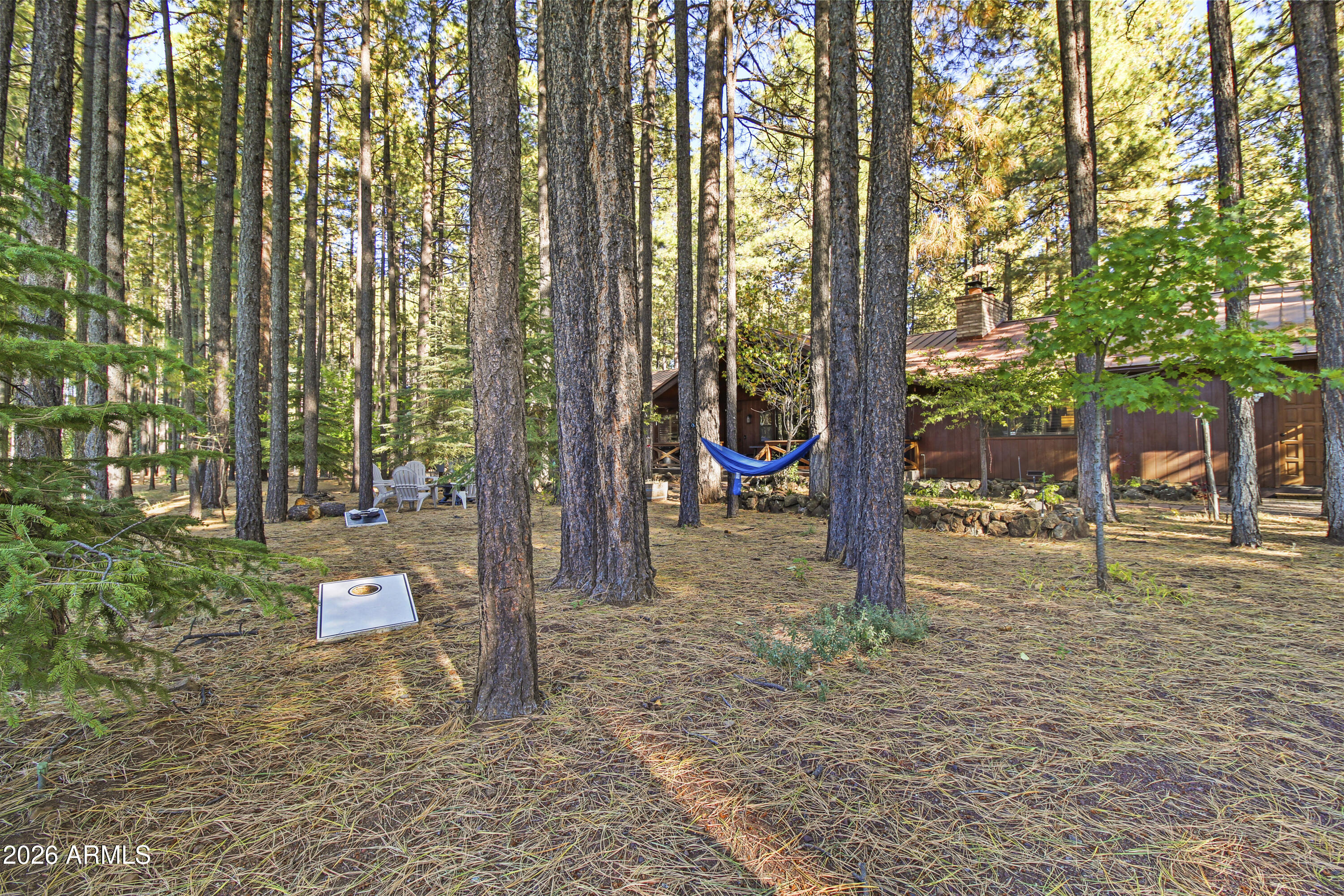 7414 Geronimo Road Pinetop, AZ 85935 - Photo 59 of 67 a backyard of a house with lots of green space and garden view