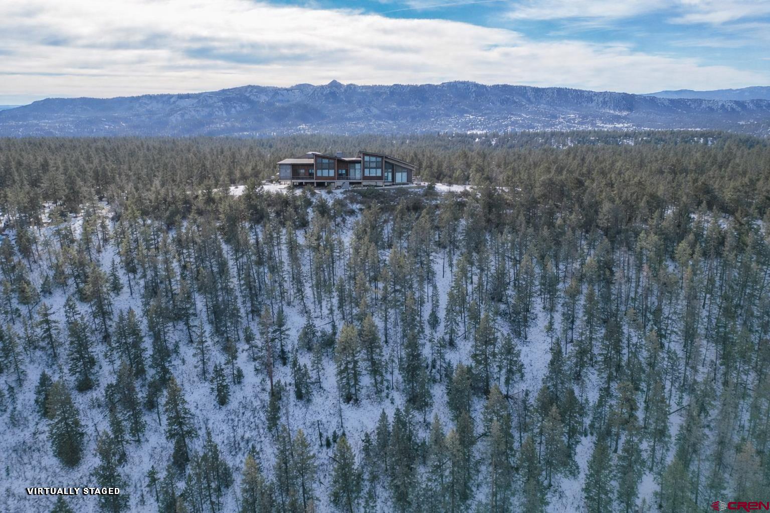 783 Gun Barrel Road Pagosa Springs, CO 81147 - Photo 27 of 28 a view of a lush green hillside and a building