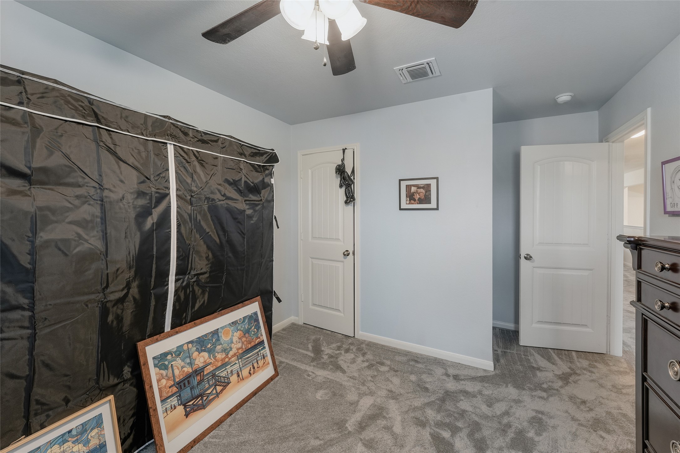 15105 Shell Bark Cove Austin, TX 78724 - Photo 23 of 30 Well-appointed bedroom featuring a ceiling fan and plush carpeting for ultimate comfort.