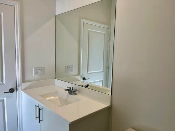 a bathroom with a shower sink and toilet