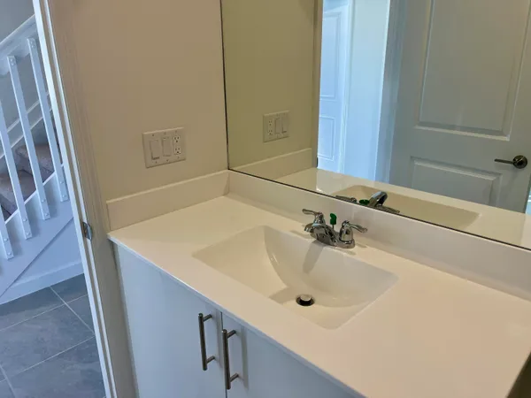 a bathroom with a sink and mirror with toilet