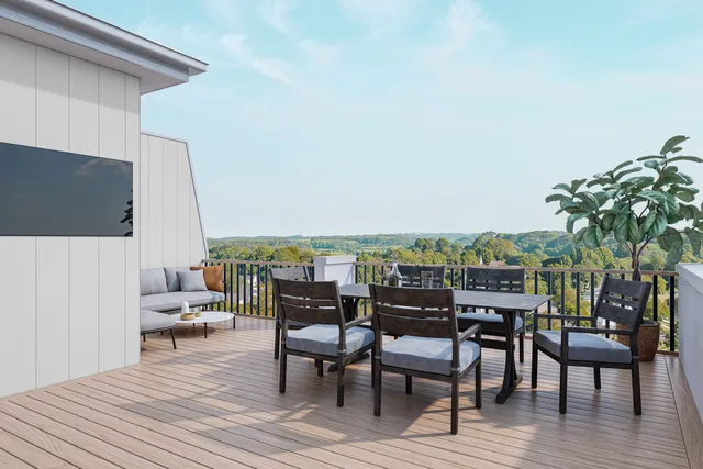 a view of a terrace with furniture and wooden floor