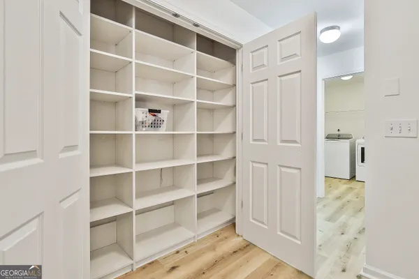 a view of walk in closet with empty racks