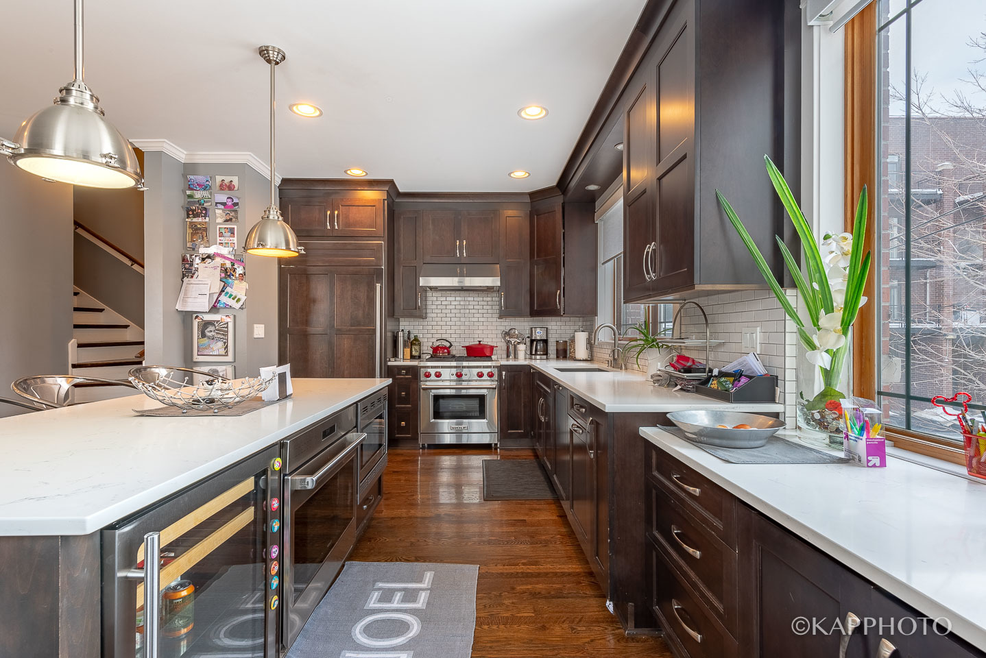 1 North Bishop Street, Unit 15 Chicago, IL 60607 - Photo 11 of 25 a kitchen with stainless steel appliances kitchen island granite countertop a sink a stove and a refrigerator