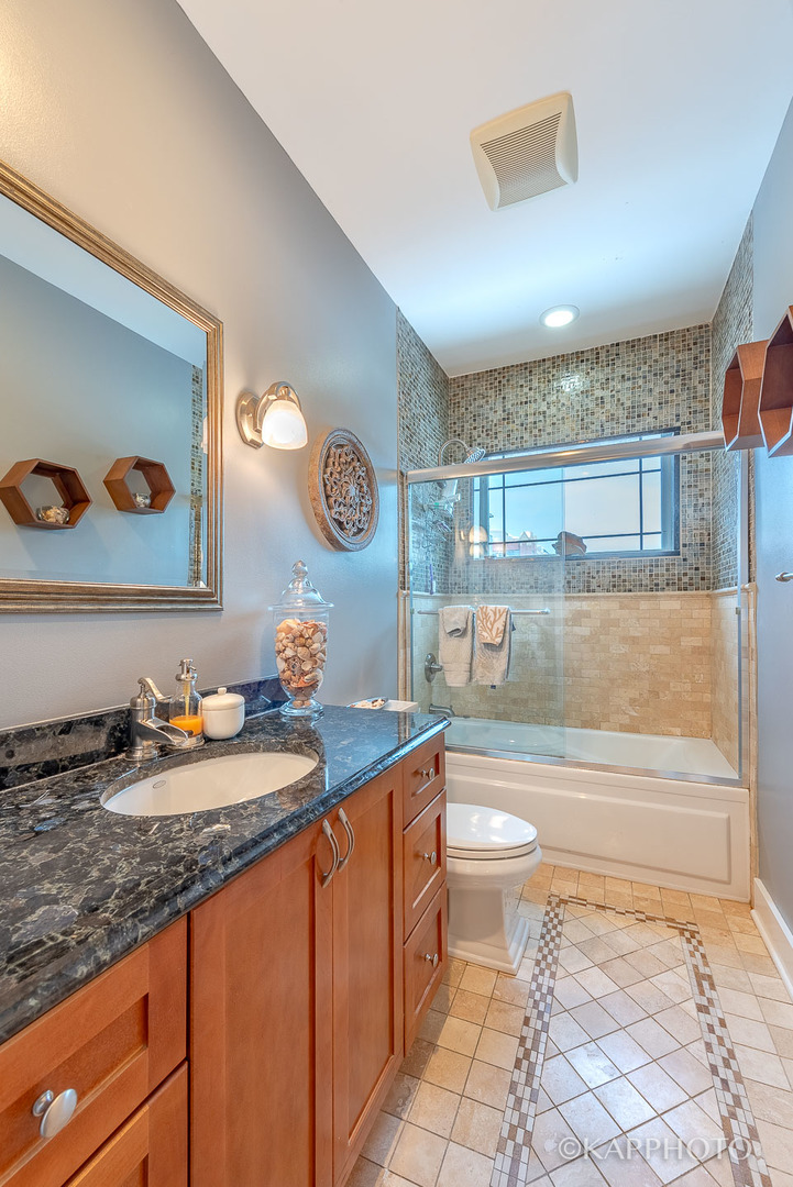 1 North Bishop Street, Unit 15 Chicago, IL 60607 - Photo 22 of 25 a bathroom with a granite countertop sink mirror vanity and toilet