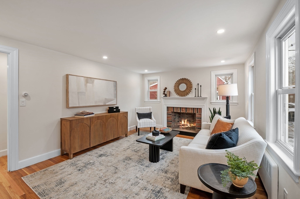 98 John Carver Road Reading, MA 01867 - Photo 11 of 40 a living room with furniture and a fireplace