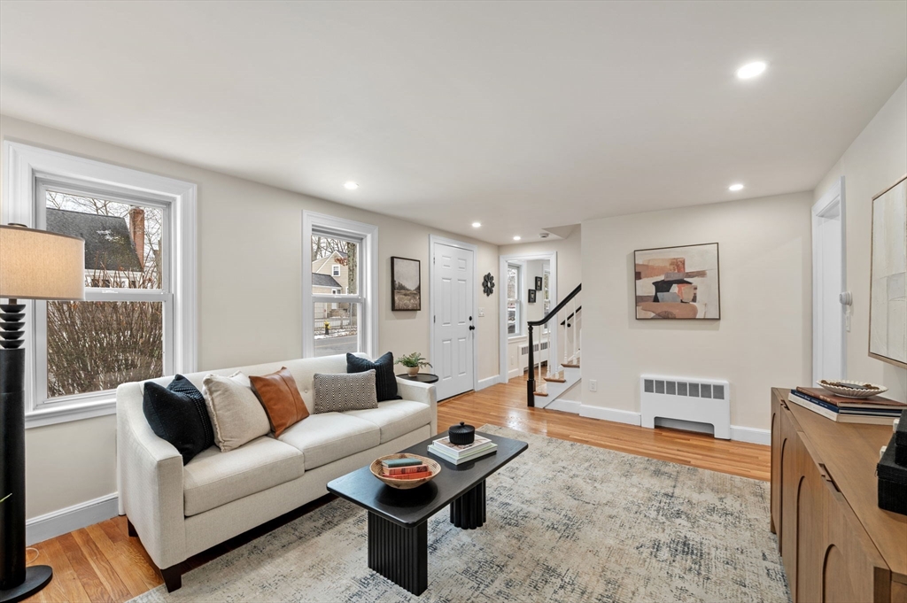 98 John Carver Road Reading, MA 01867 - Photo 13 of 40 a living room with furniture a couch and a flat screen tv