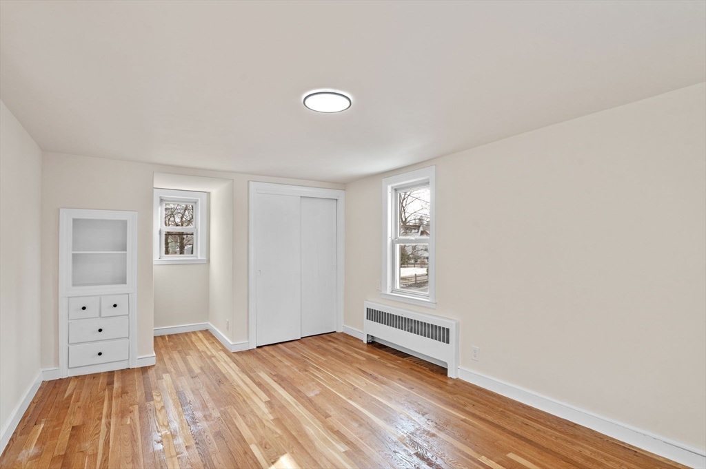 98 John Carver Road Reading, MA 01867 - Photo 22 of 40 a view of empty room with wooden floor and fan