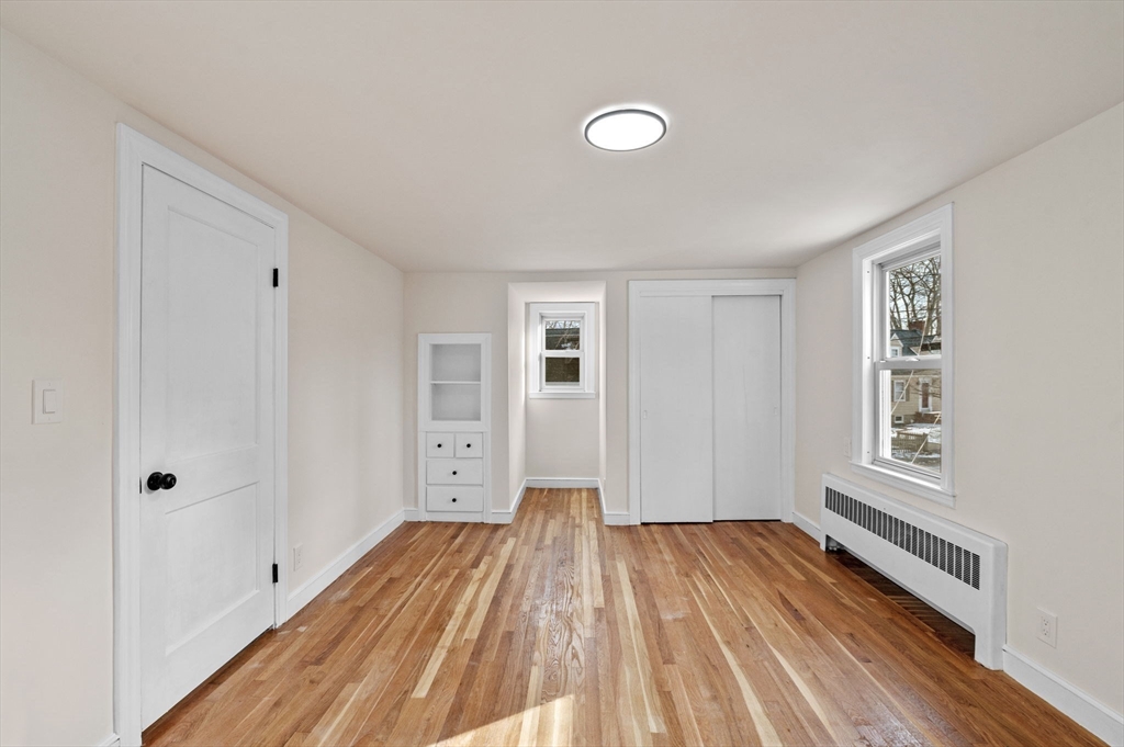 98 John Carver Road Reading, MA 01867 - Photo 24 of 40 a view of empty room with wooden floor and fan