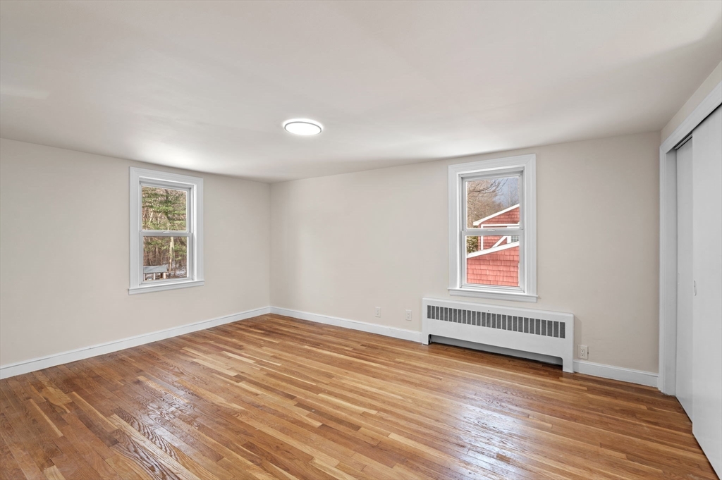 98 John Carver Road Reading, MA 01867 - Photo 28 of 40 a view of empty room with wooden floor and fan