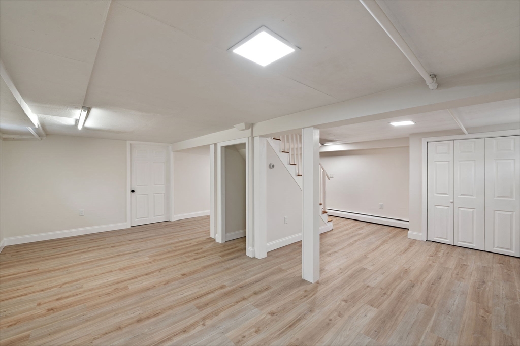 98 John Carver Road Reading, MA 01867 - Photo 30 of 40 wooden floor in an empty room with a window