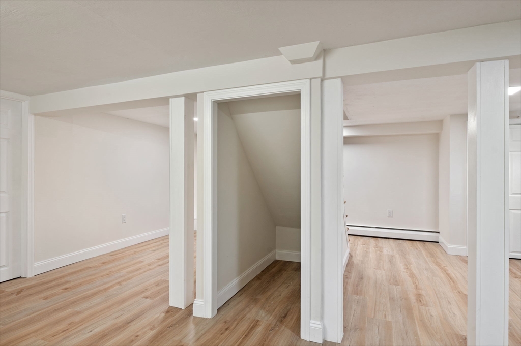 98 John Carver Road Reading, MA 01867 - Photo 31 of 40 a view of an empty room with wooden floor