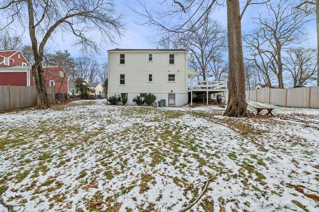 98 John Carver Road Reading, MA 01867 - Photo 36 of 40 a view of a house with a snow on the wall