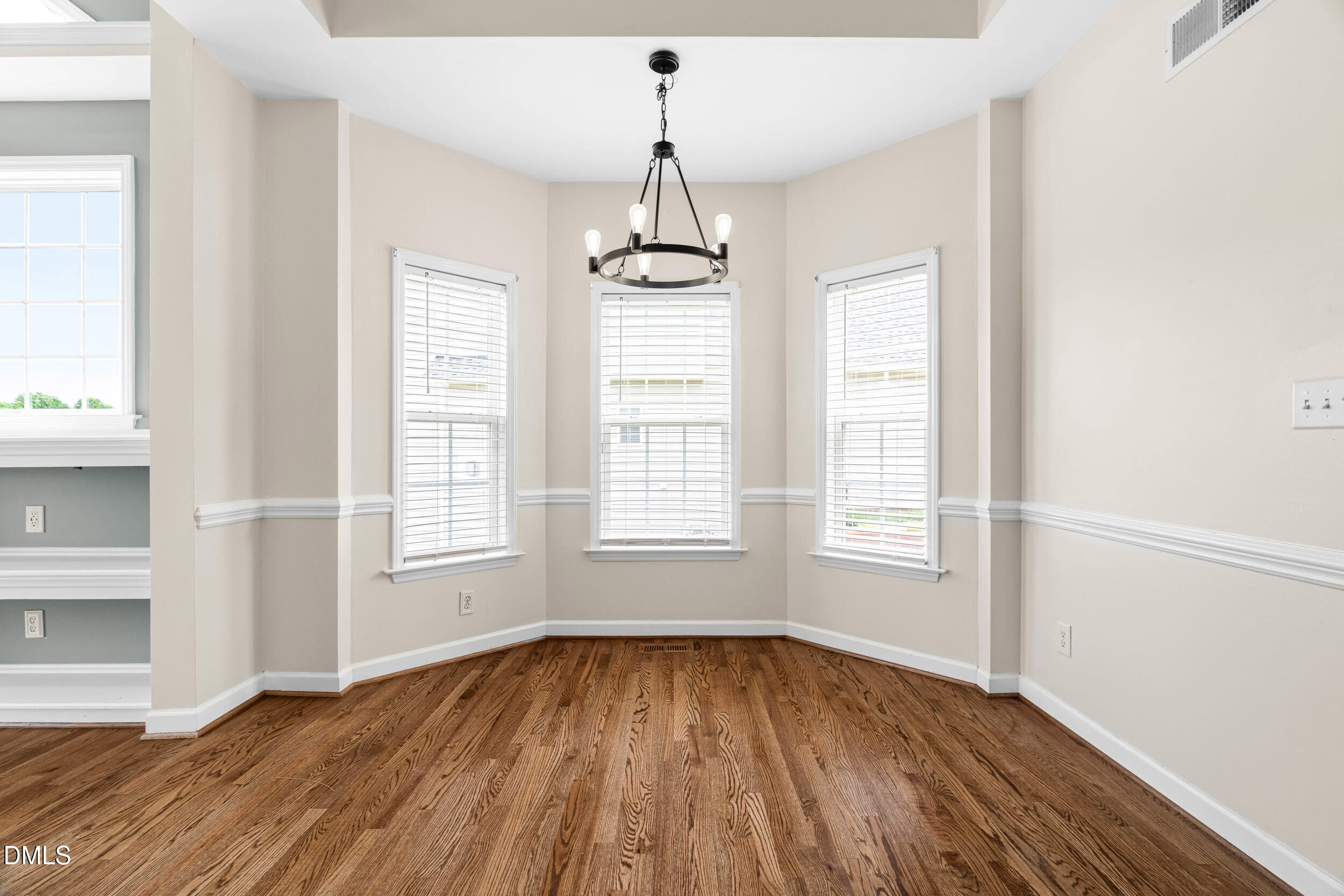744 Seastone Street Raleigh, NC 27603 - Photo 20 of 53 an empty room with wooden floor and windows