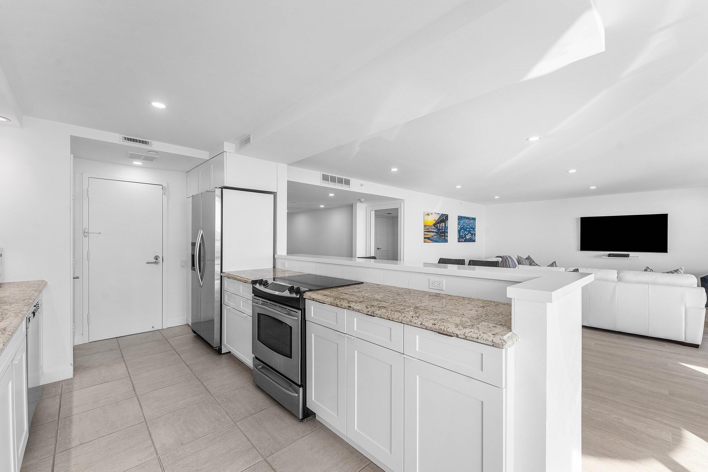 250 South Ocean Boulevard, Unit 4F Boca Raton, FL 33432 - Photo 16 of 45 a kitchen with a stove and a refrigerator