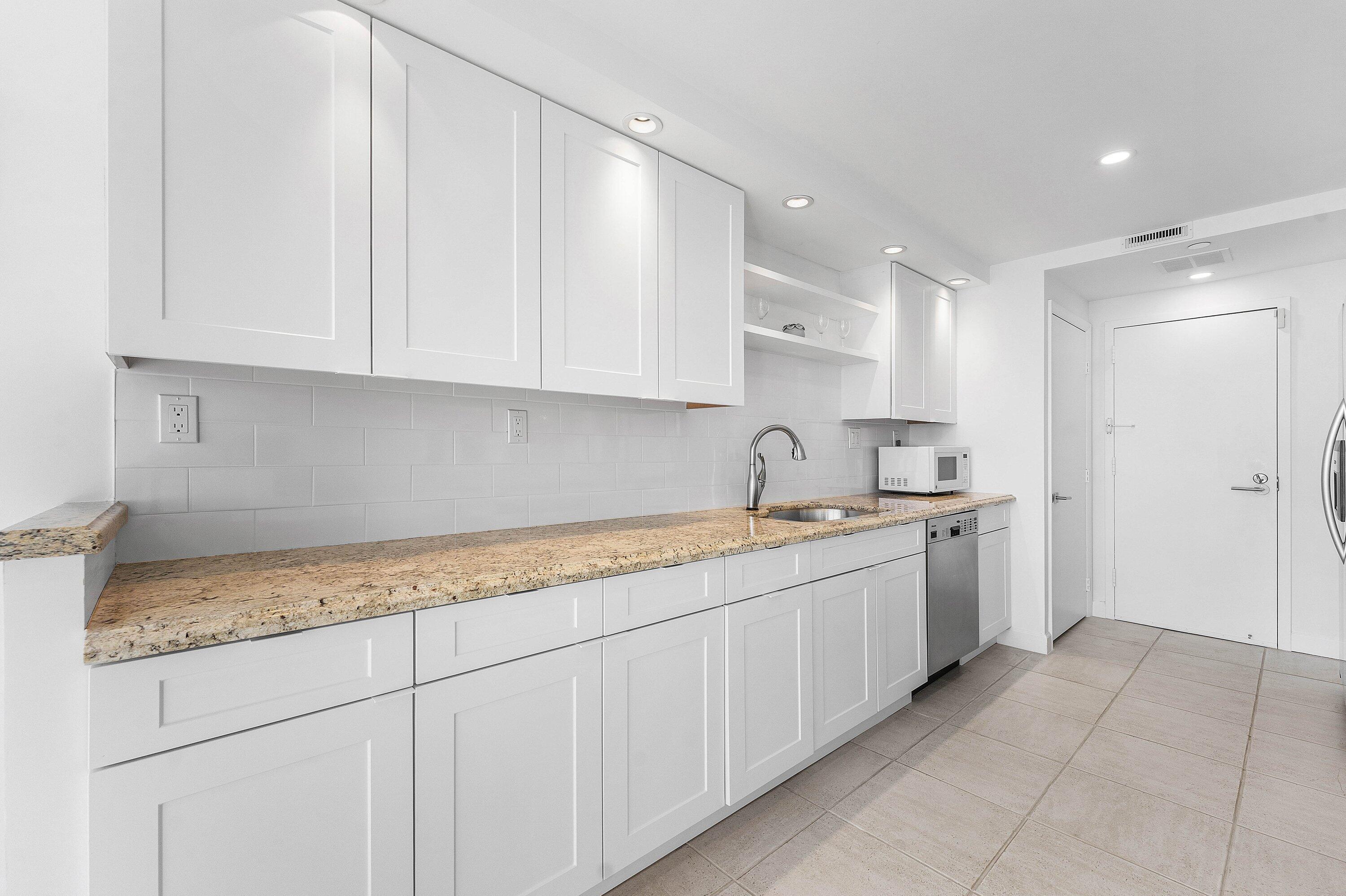 250 South Ocean Boulevard, Unit 4F Boca Raton, FL 33432 - Photo 17 of 45 a kitchen with a sink and cabinets