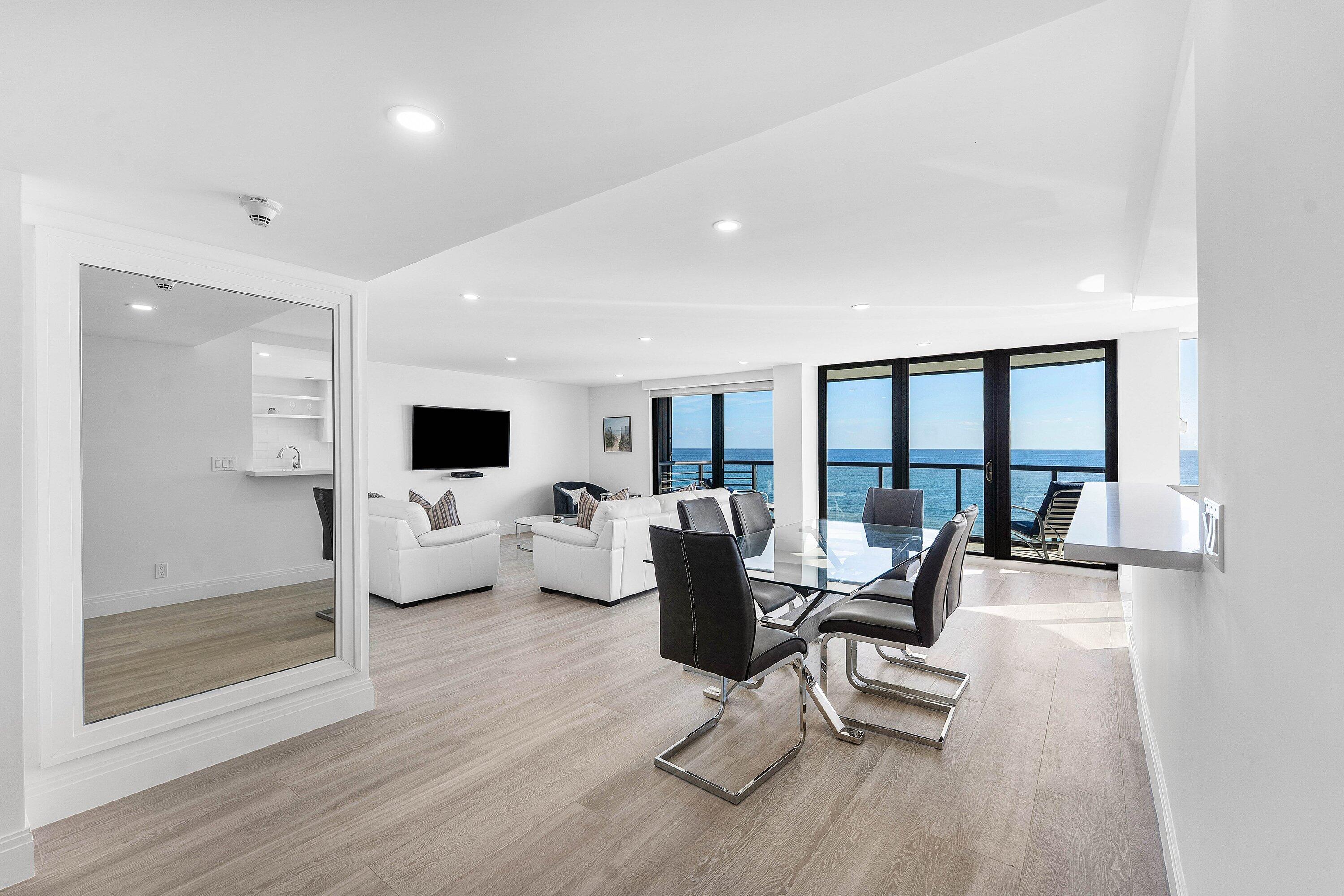 250 South Ocean Boulevard, Unit 4F Boca Raton, FL 33432 - Photo 2 of 45 a living room with furniture and a flat screen tv