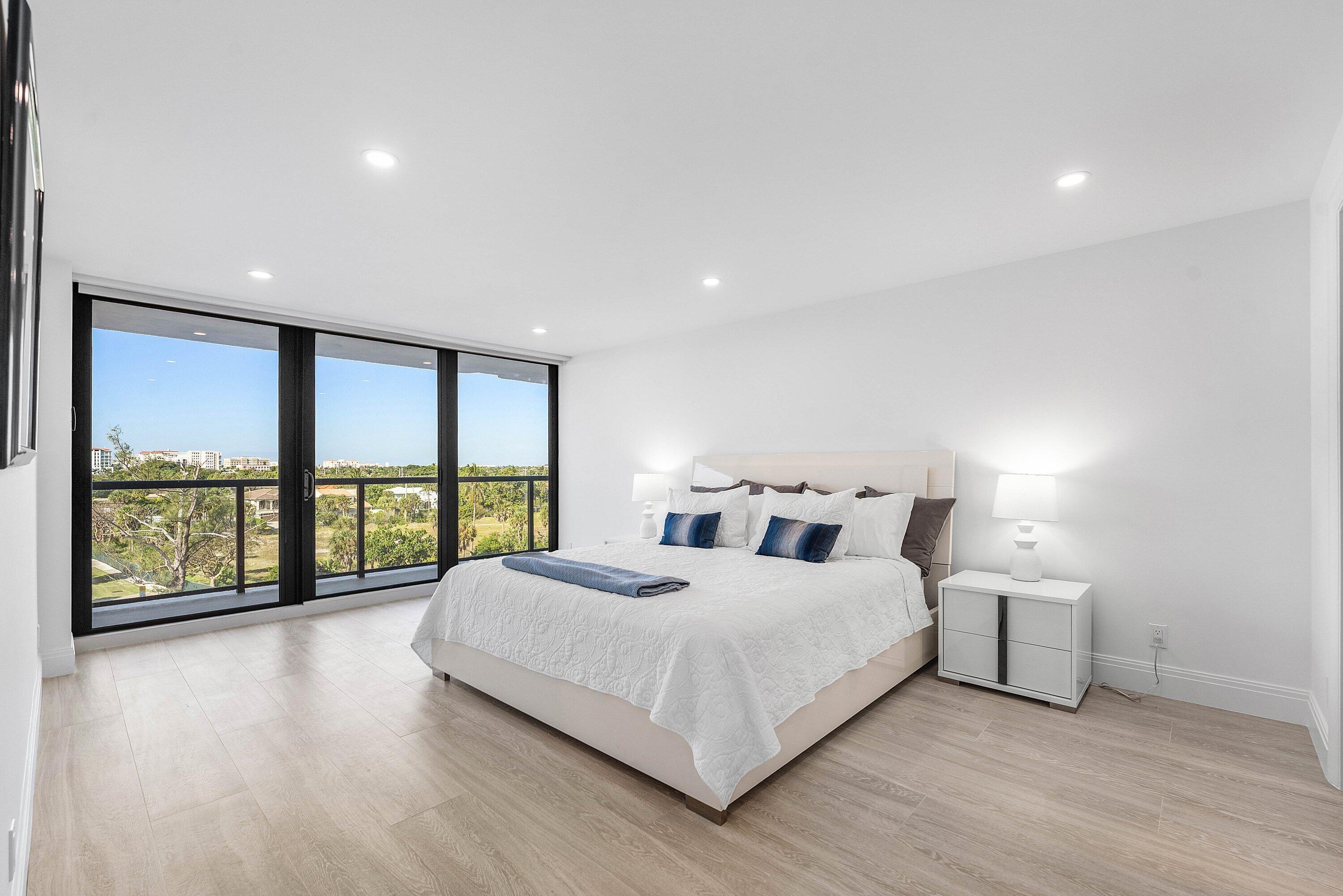 250 South Ocean Boulevard, Unit 4F Boca Raton, FL 33432 - Photo 27 of 45 a bedroom with a large bed and a large window